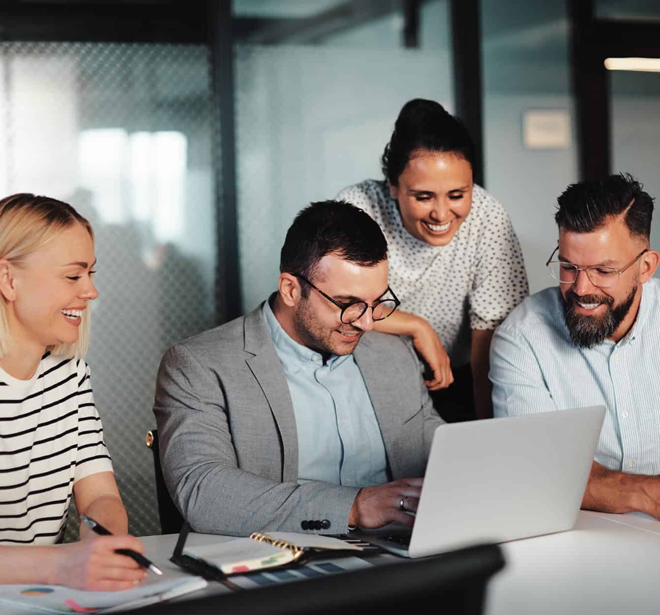 Coworkers-gathered-around-laptop-narrow_compressed