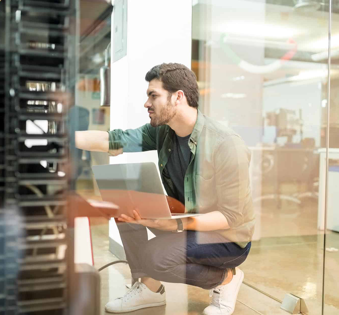 Tech-professional-setting-up-servers-in-office-narrow