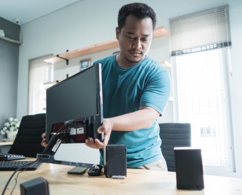 Office worker setting up computer on desk